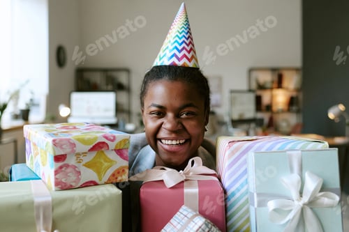 Preview: Smiling Woman Celebrates Birthday with Gifts at Home