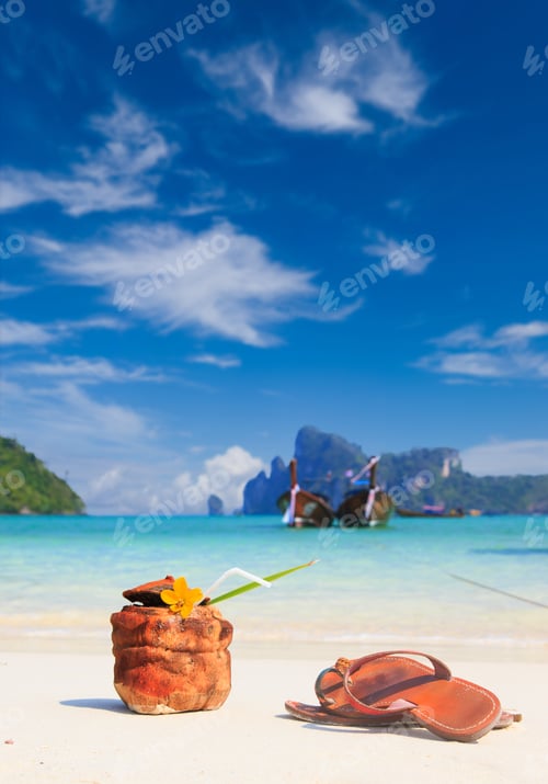 Preview: Coconut cocktail with drinking straw and sandals