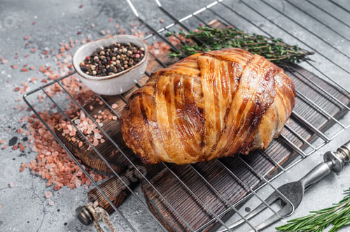 Preview: Baked meatloaf with bacon, meat loaf on a grill. Gray background. Top view