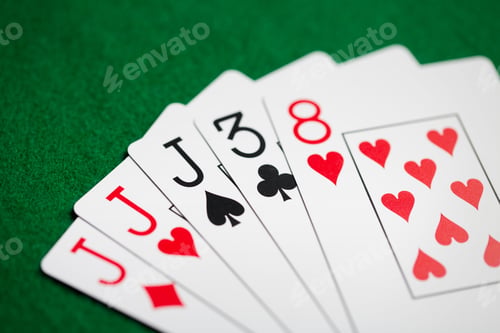 Preview: poker hand of playing cards on green casino cloth