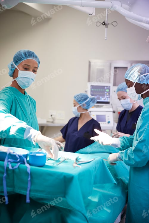 Preview: Surgical Team Working On Patient In Hospital Operating Theatre