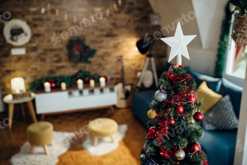 Preview: White star shape on top of Christmas tree at home.