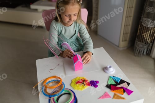 Preview: Girl Creatively Playing with a 3D Pen at Home