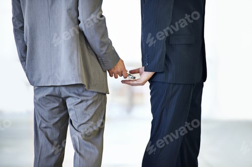 Preview: Money passing hands. Cropped studio shot of money being placed in a mans hand.