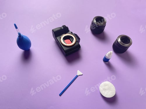 Preview: a person cleaning the photo camera and lens equipment from dirt and dust