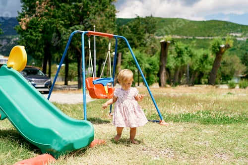 Preview: Little girl goes to the slide in the playground