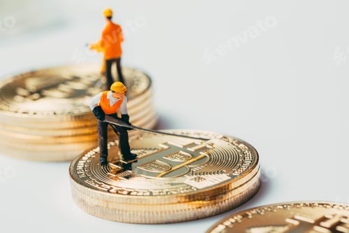 Preview: Miniature worker working on Bitcoin.