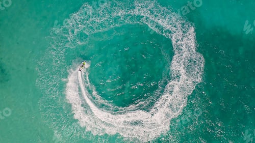 Preview: Jet ski or boat drawing a shape on sea ocean turquoise water. Adventure extreme recreation activity.