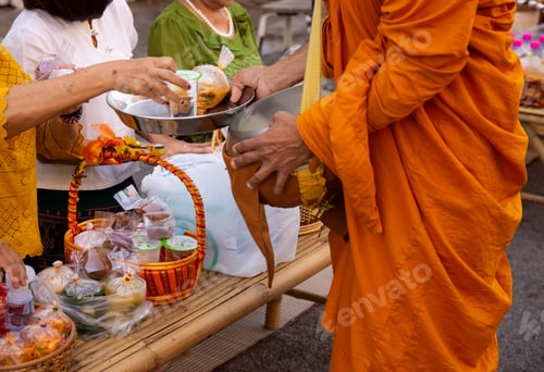 Preview: Thai people make merit by giving food to monks.