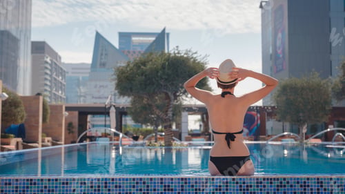 Preview: asian woman relaxing in swimming pool spa