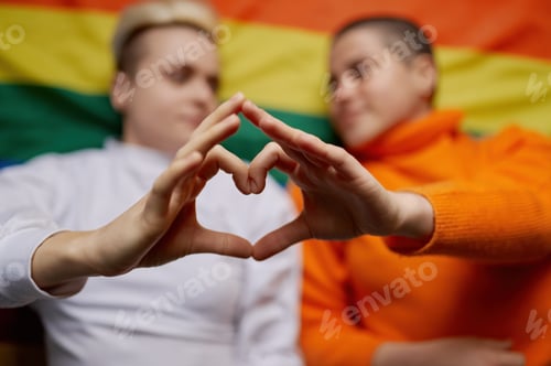 Preview: Selective focus on lesbian woman couple gesturing heart sign with hands