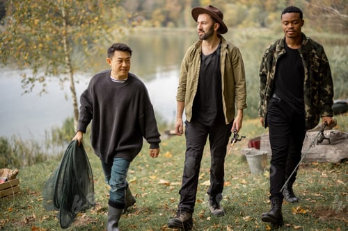 Preview: Men walk with dog and fishing equipment in nature