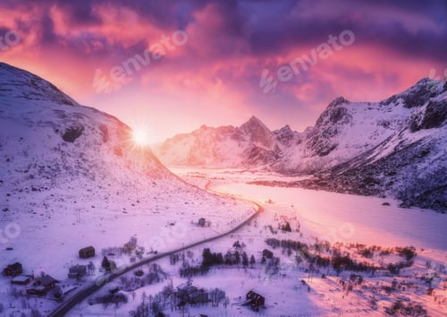 Preview: Aerial view of snowy mountains, road, houses and purple sky