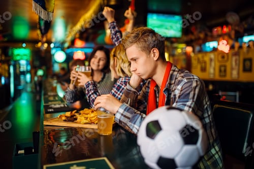 Preview: Upset football fan at the counter in sports bar