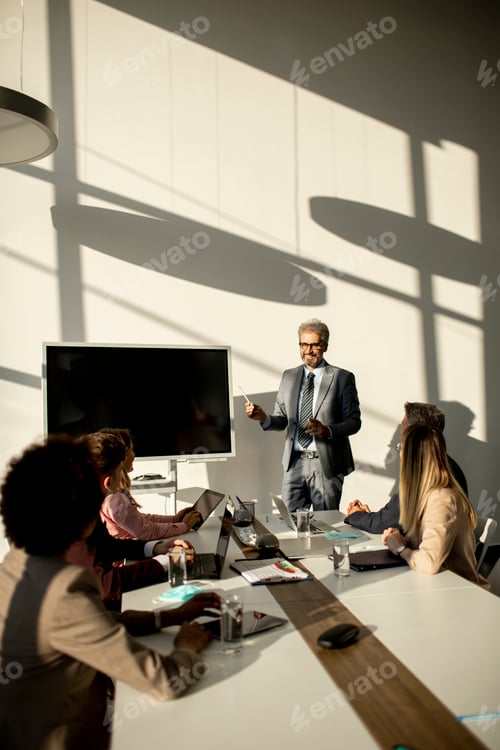 Preview: View at group of business people working together and preparing new project on a meeting in office