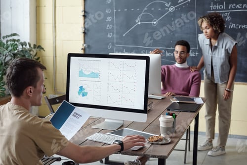 Preview: Young economist looking at financial data on computer screen