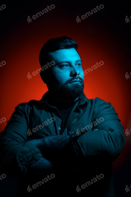 Preview: Confident man with crossed arms in neon light
