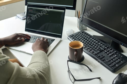 Preview: Programmer writing codes on laptop