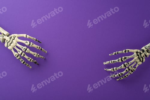 Preview: Embrace the spooky Halloween night festivity. A top-view snapshot featuring two skeleton hands