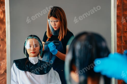 Preview: Hairdresser colouring hair of woman
