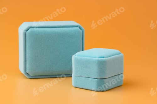 Preview: Blue jewelry box on yellow background close up