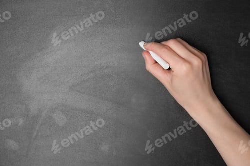 Preview: Woman with white chalk near blackboard, closeup. Space for text