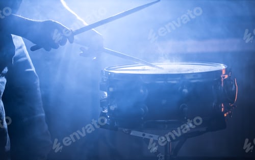 Preview: man playing the snare drum on a beautiful colored background