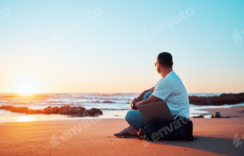 Preview: Freelancer working remotely on the beach enjoying sunset view