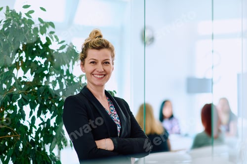 Preview: Brunette Businesswoman with Crossed Arms Standing in Front of Modern Office.