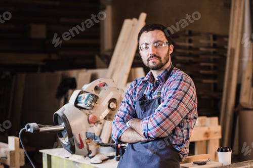 Preview: Happy young handyman carpenter in workshop, smiling