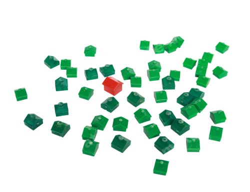 Preview: Monopoly houses and a hotel - concept of real estate depicting standing out from the crowd