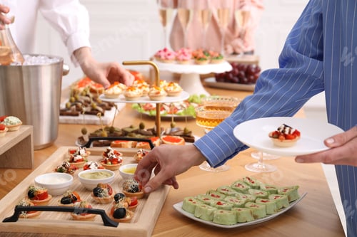 Preview: People with different appetizers at buffet, closeup
