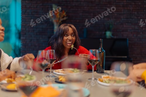Preview: Friends enjoying delicious meal and wine together at home