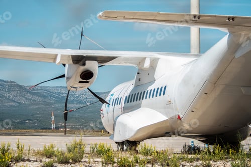 Preview: Plane cargo-passenger aircraft ,side view from the tail, parked on an airport