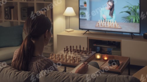 Preview: Woman learning chess on TV