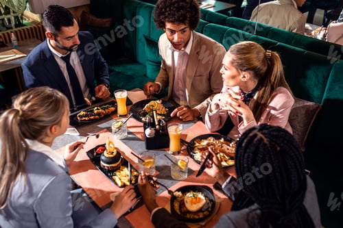 Preview: Group of business people in restaurant at lunch.