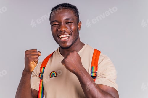 Preview: hispanic student man with rainbow badge on t-shirt in studio isolate
