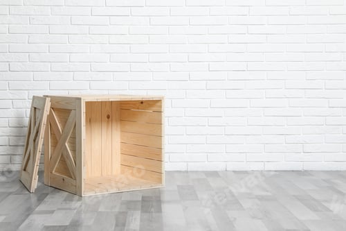 Preview: Wooden crate on floor at white brick wall. Space for text