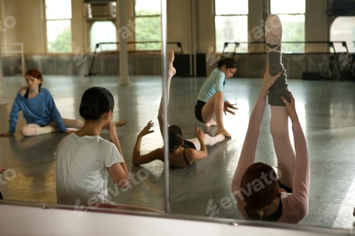Preview: Dancers practicing in a sunlit studio reflected in a large mirror