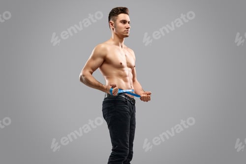Preview: Young athlete measuring waist