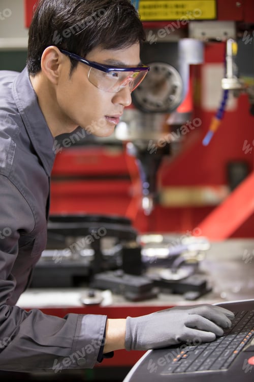 Preview: Confident engineer working in the factory
