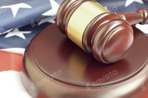 Preview: Justice mallet on United States flag in a courtroom during a judicial trial