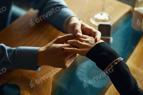 Preview: Caucasian Young Adult Man Holding Hand of Caucasian Young Adult Woman