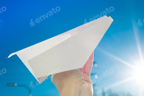 Preview: Abstract paper plane, in hand, sky, sun background