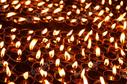 Preview: Butter lamps with flames near Bodhnath stupa in Kathmandu, Nepal