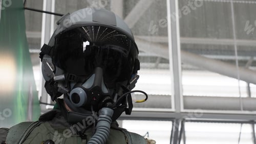 Preview: A fighter pilot helmet equipped with a dark visor and oxygen mask.