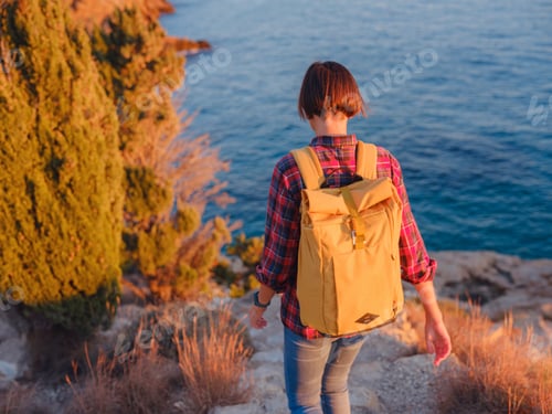 Preview: Young woman hiking on rocky beach in Spain, Benidorm