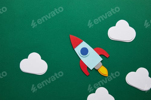 Preview: top view of rocket and clouds on green chalkboard