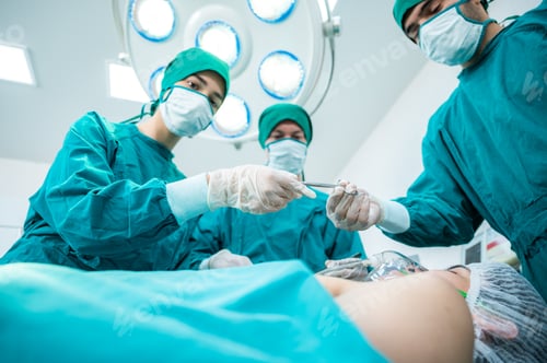 Preview: Surgeon Medical Team Performing Emergency Surgical Operation in Bright Modern Operating Room