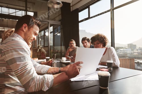 Preview: Businessman explaining business plan to his colleagues